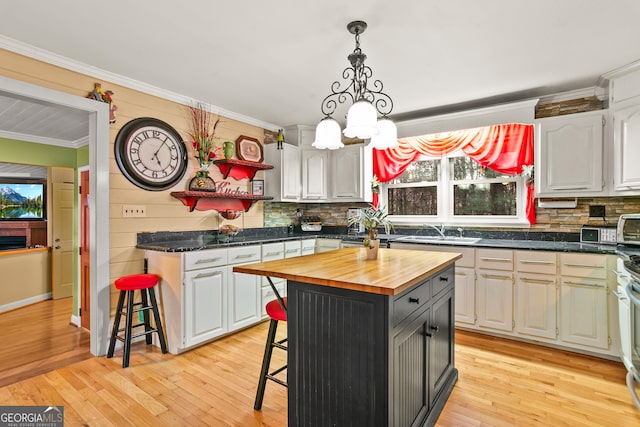 kitchen featuring a kitchen bar, white cabinets, and a kitchen island