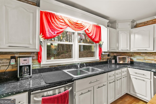 kitchen with sink, light hardwood / wood-style flooring, stainless steel dishwasher, crown molding, and white cabinets