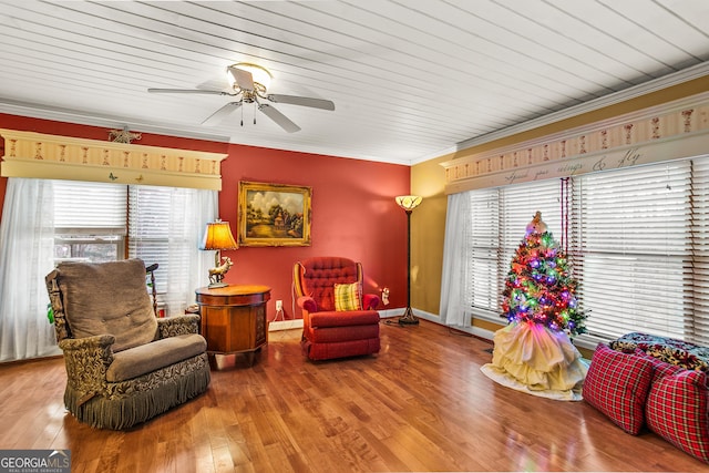 sitting room featuring hardwood / wood-style flooring, a wealth of natural light, and crown molding