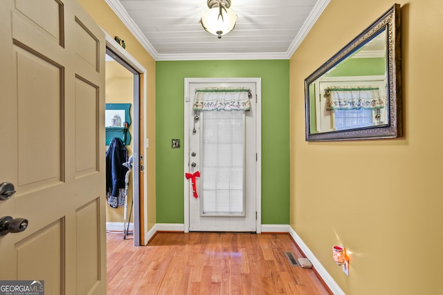 foyer with light hardwood / wood-style floors and ornamental molding