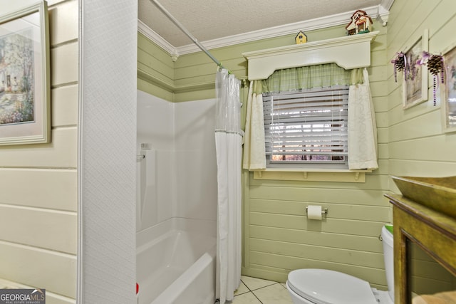 bathroom with tile patterned floors, a textured ceiling, shower / bathtub combination with curtain, toilet, and wood walls