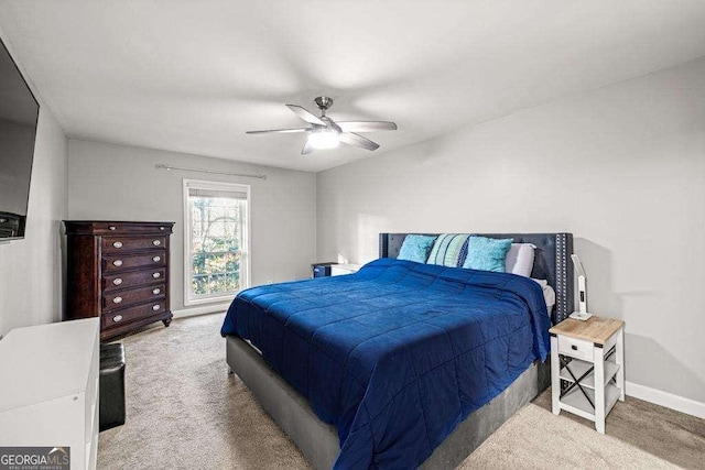 bedroom with ceiling fan and light colored carpet