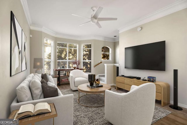 living room with hardwood / wood-style flooring, ornamental molding, and ceiling fan