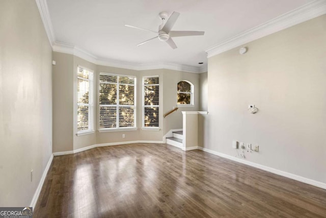 unfurnished room featuring dark hardwood / wood-style flooring, ornamental molding, and ceiling fan