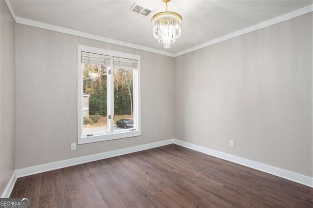 unfurnished room with ornamental molding, dark wood-type flooring, and a notable chandelier