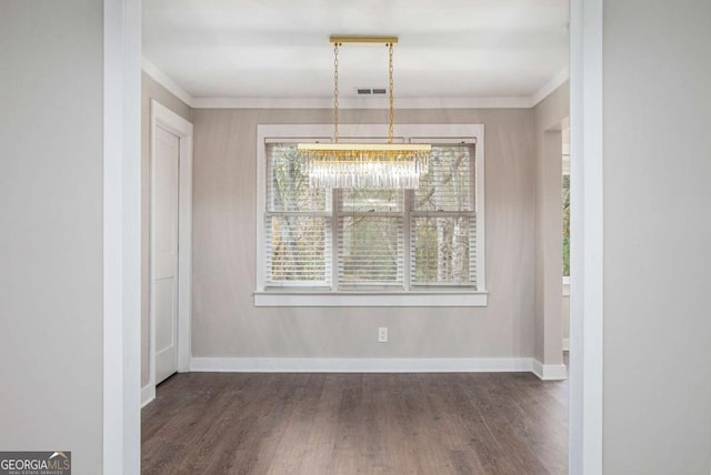 unfurnished dining area with crown molding and dark wood-type flooring