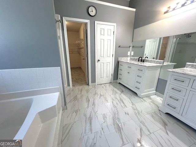 bathroom with a tub to relax in and vanity