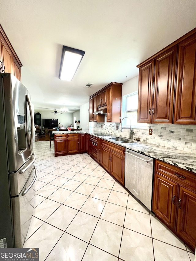 kitchen with sink, ceiling fan, light tile patterned floors, light stone counters, and stainless steel appliances