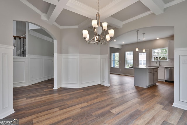 unfurnished dining area featuring crown molding, beam ceiling, coffered ceiling, a notable chandelier, and dark hardwood / wood-style flooring