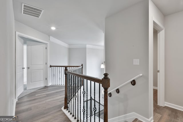 hall featuring crown molding and hardwood / wood-style flooring