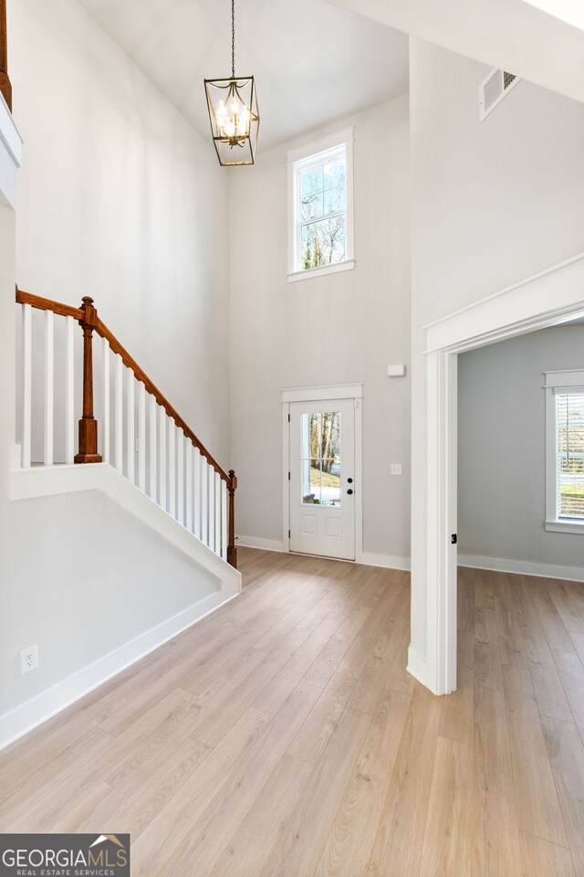 unfurnished living room featuring dark hardwood / wood-style floors, ceiling fan with notable chandelier, beamed ceiling, coffered ceiling, and a brick fireplace