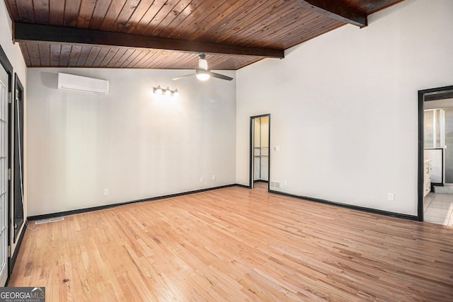 spare room with a wall mounted AC, wood ceiling, and light wood-type flooring