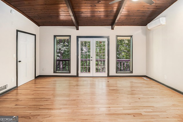 unfurnished room featuring french doors, light wood-type flooring, a wall mounted AC, and wooden ceiling