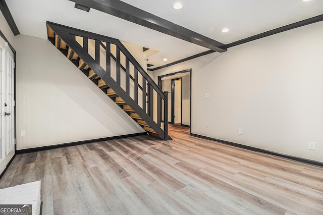 staircase featuring beam ceiling, crown molding, and wood-type flooring