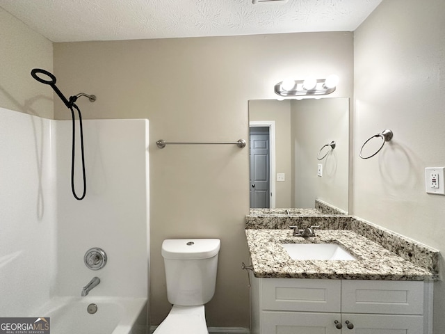 full bathroom featuring toilet, vanity, a textured ceiling, and washtub / shower combination