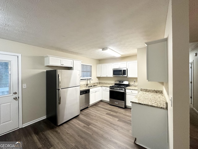 kitchen featuring sink, white cabinets, stainless steel appliances, and light wood-type flooring