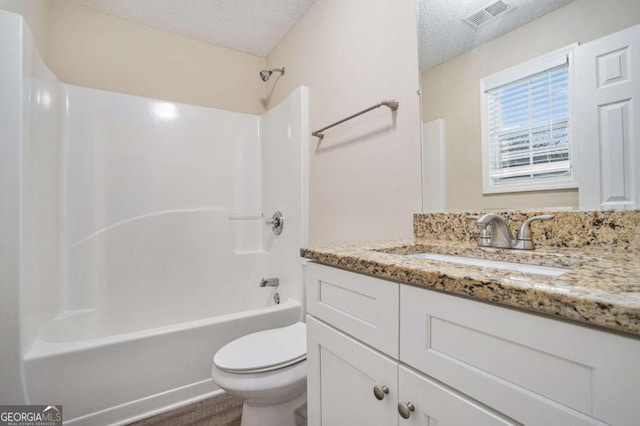 full bathroom featuring vanity, a textured ceiling, toilet, and shower / bathtub combination