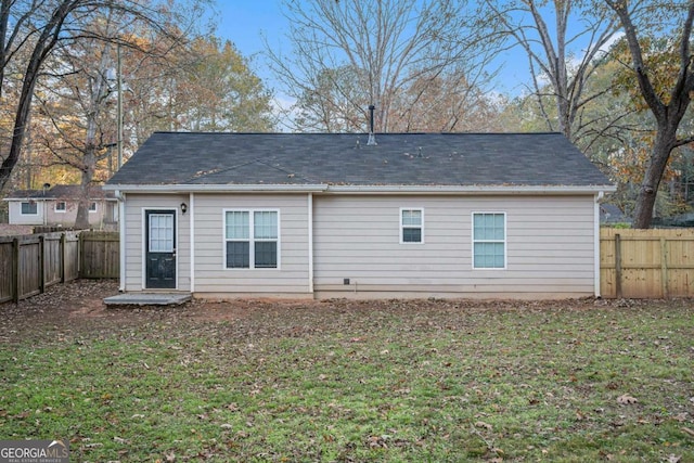 back of house featuring a lawn