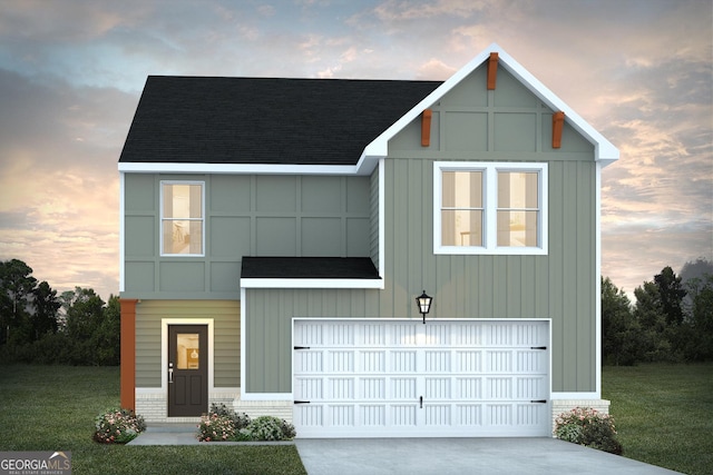 view of front of house with a yard and a garage