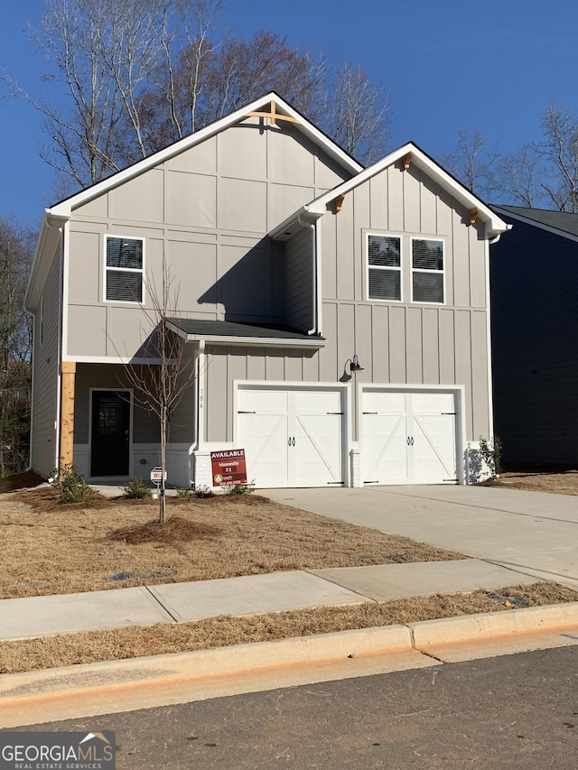 view of front of home featuring an attached garage, board and batten siding, and concrete driveway