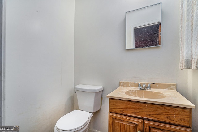 bathroom featuring vanity and toilet