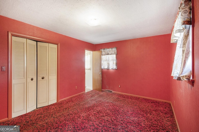 1228 Old Rockmart Rd SE, Silver Creek, GA 30173 - unfurnished bedroom featuring carpet, a closet, a textured ceiling, and baseboards