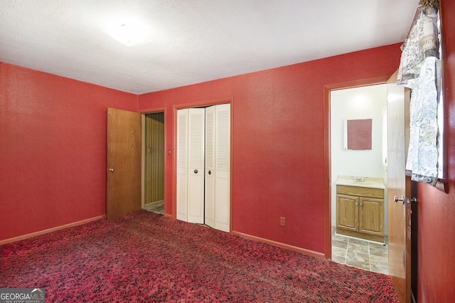 1228 Old Rockmart Rd SE, Silver Creek, GA 30173 - unfurnished bedroom featuring a closet, a sink, carpet flooring, baseboards, and ensuite bath