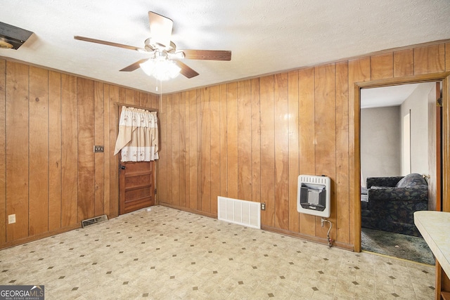 1228 Old Rockmart Rd SE, Silver Creek, GA 30173 - empty room with heating unit, tile patterned floors, ceiling fan, wood walls, and a textured ceiling