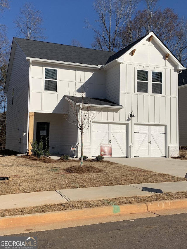 modern farmhouse with an attached garage, driveway, and board and batten siding