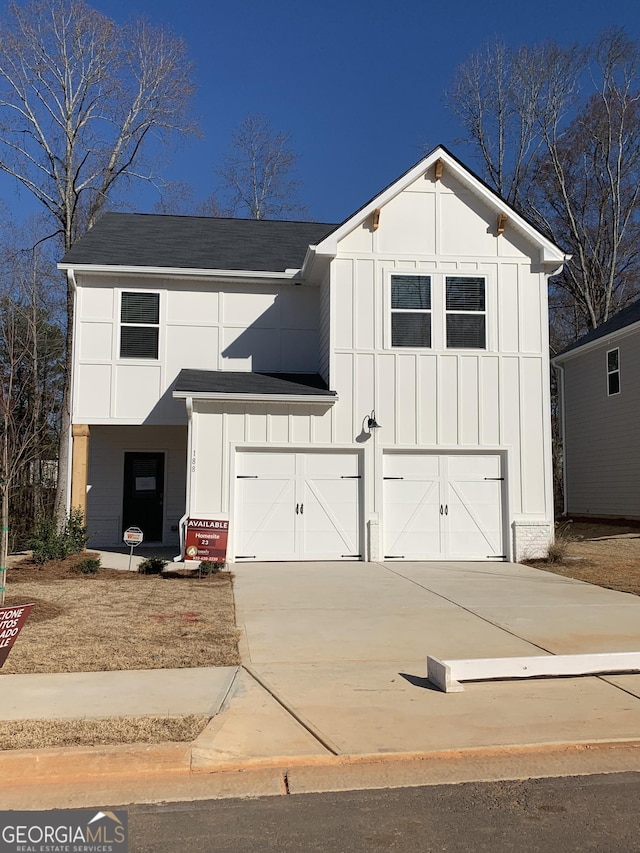 modern inspired farmhouse with driveway, board and batten siding, an attached garage, and roof with shingles