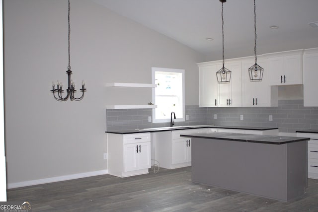 kitchen featuring white cabinets, a center island, and dark wood-type flooring