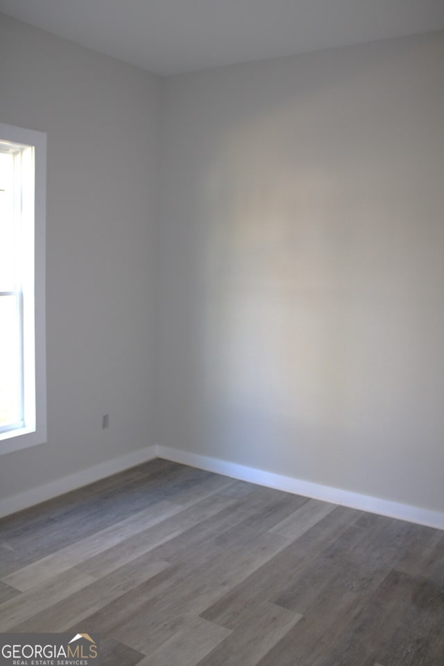 unfurnished room featuring wood-type flooring