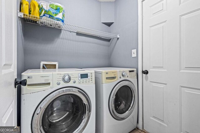 clothes washing area featuring washing machine and clothes dryer