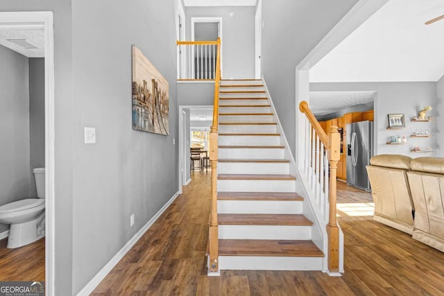 staircase featuring wood-type flooring