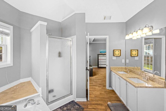 bathroom with hardwood / wood-style flooring, vanity, an enclosed shower, and vaulted ceiling