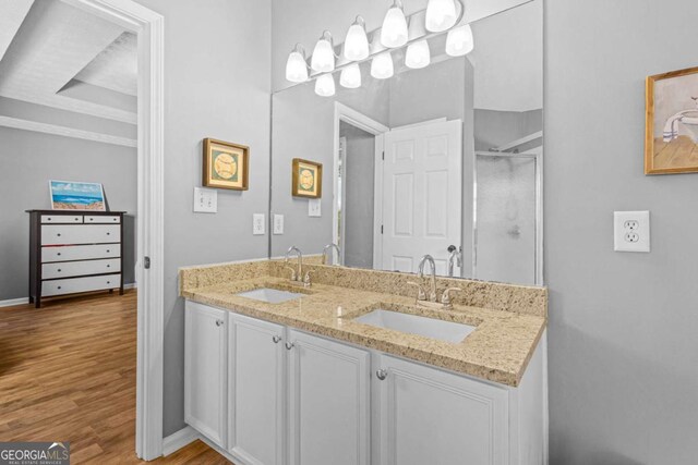 bathroom featuring hardwood / wood-style floors, vanity, and a shower with door