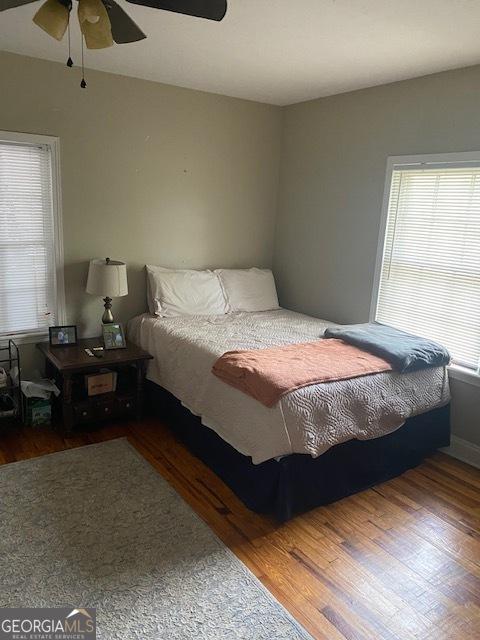 bedroom with wood-type flooring and ceiling fan