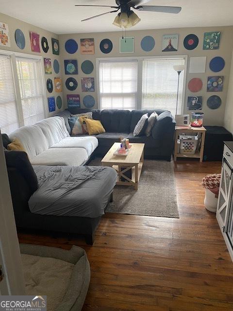 living room with wood-type flooring and ceiling fan