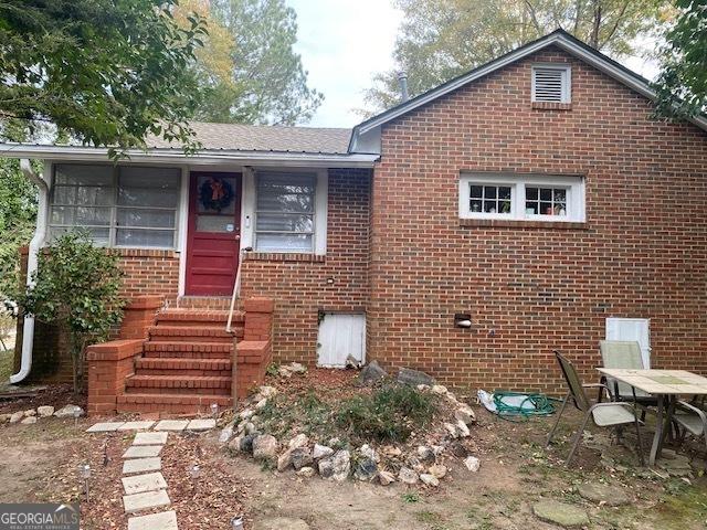 view of front facade with a sunroom