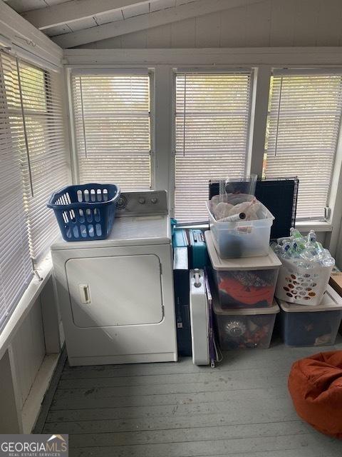 washroom with washing machine and dryer, light hardwood / wood-style floors, and plenty of natural light