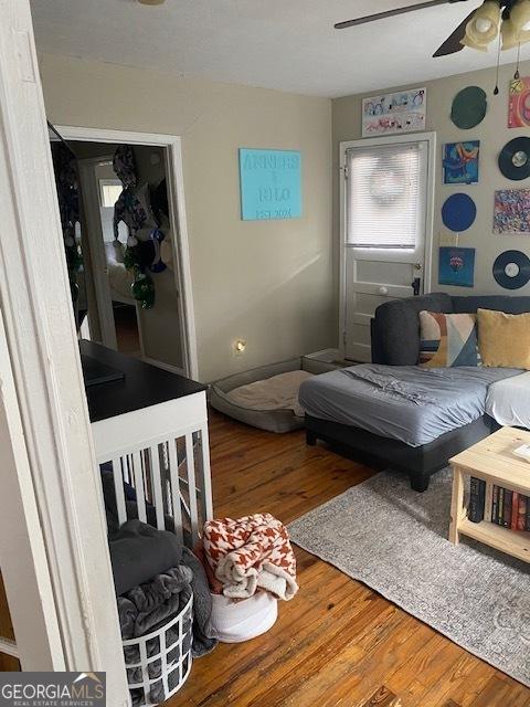 living room featuring hardwood / wood-style floors and ceiling fan