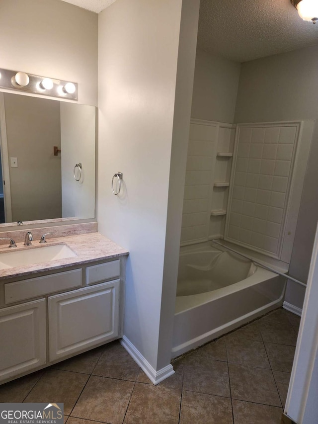 bathroom with tile patterned floors, a textured ceiling, and shower / washtub combination