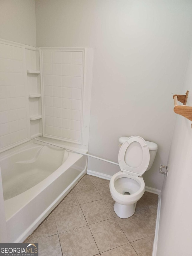 bathroom with bathing tub / shower combination, tile patterned flooring, and toilet