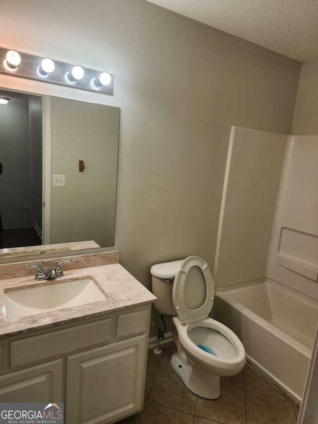 full bathroom with vanity, bathtub / shower combination, tile patterned floors, toilet, and a textured ceiling