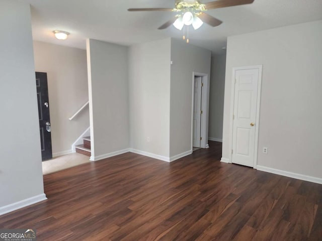 unfurnished room featuring ceiling fan and dark hardwood / wood-style flooring