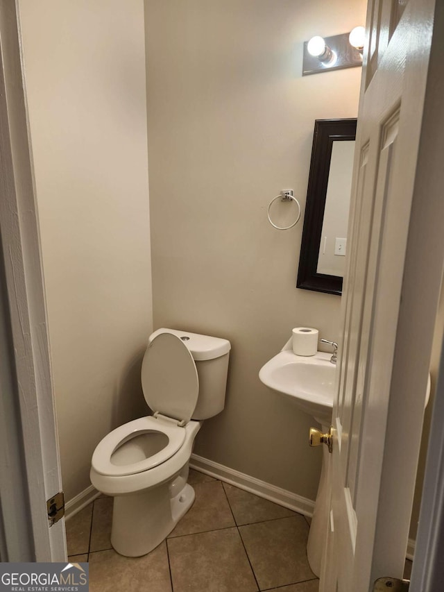 bathroom with tile patterned flooring and toilet