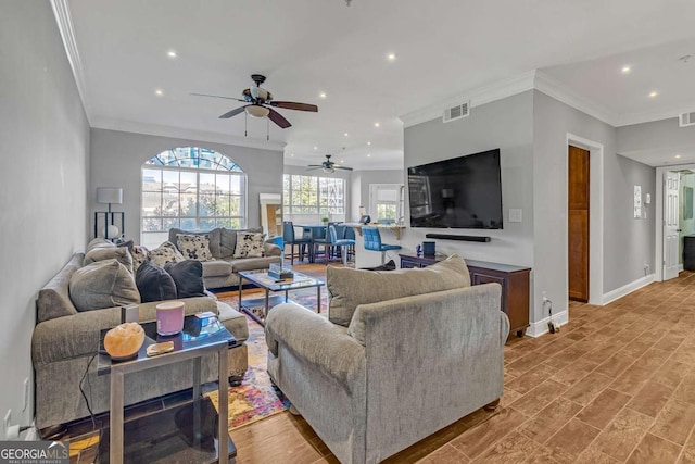 living room featuring crown molding, ceiling fan, and light hardwood / wood-style floors