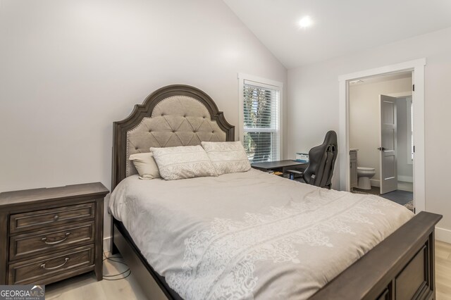 bedroom with connected bathroom, high vaulted ceiling, and ceiling fan