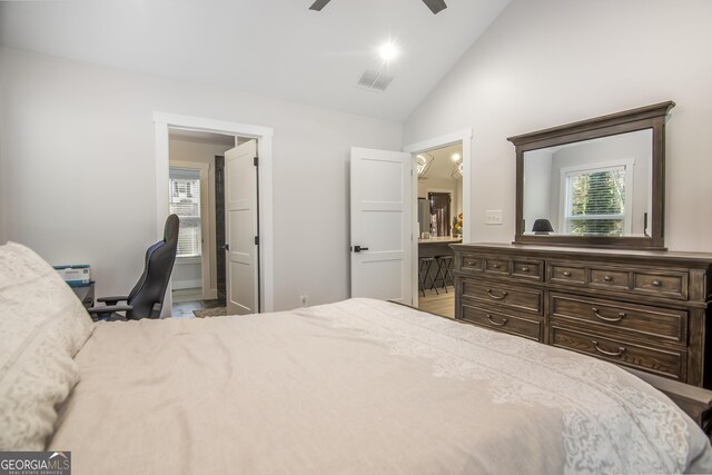 bedroom with light hardwood / wood-style floors, vaulted ceiling, and ceiling fan