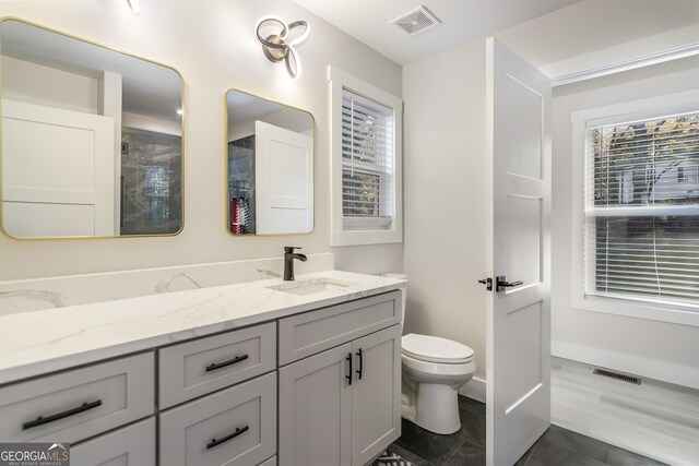 full bathroom with vanity, toilet, and shower / tub combo